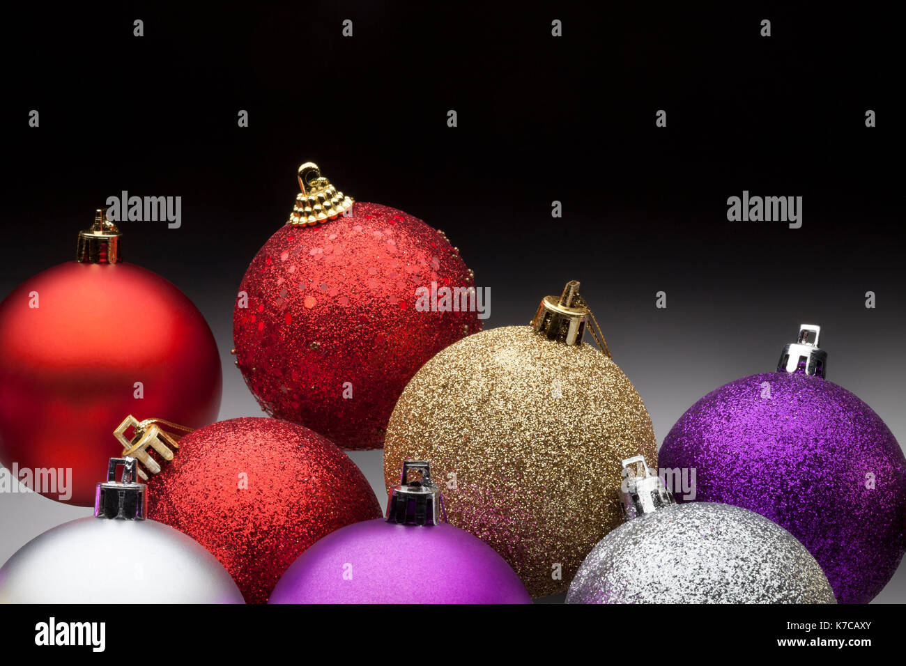 Colorful christmas balls set against black background Stock Photo