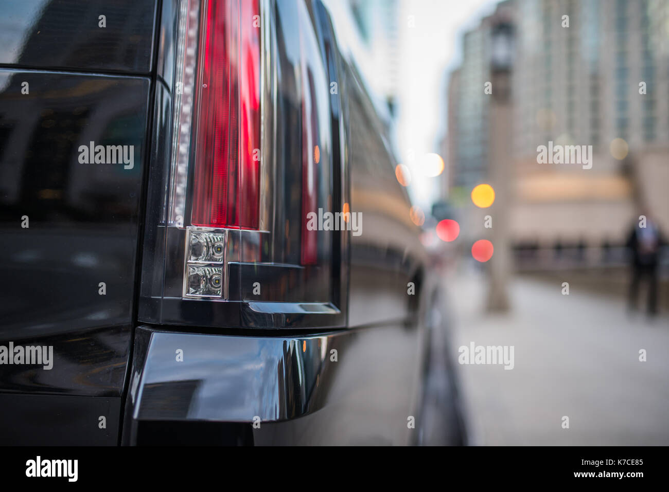Stop light of a black SUV vehicle with blurred background Stock Photo