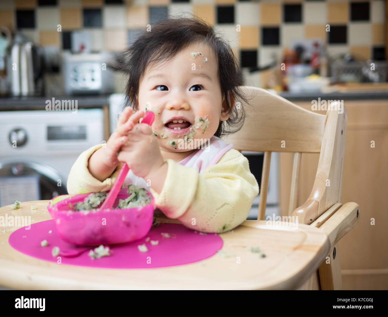 baby eating messy mashed potato Stock Photo Alamy