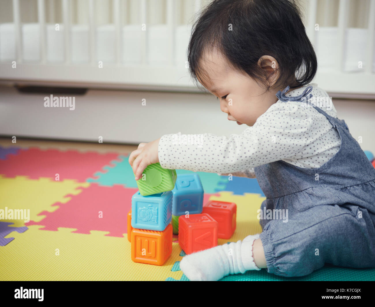 Cute baby girl playing toys at home Stock Photo - Alamy