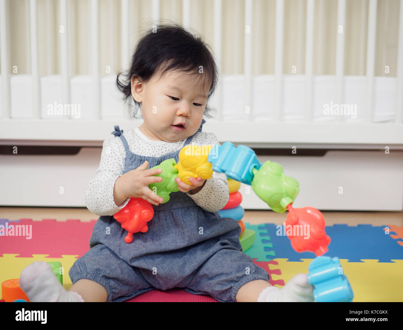 Cute baby girl playing toys at home Stock Photo - Alamy