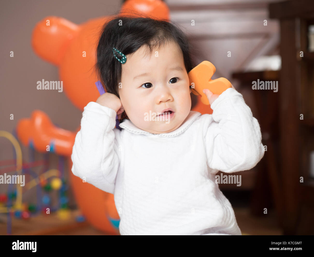 baby girl playing toy at home Stock Photo - Alamy