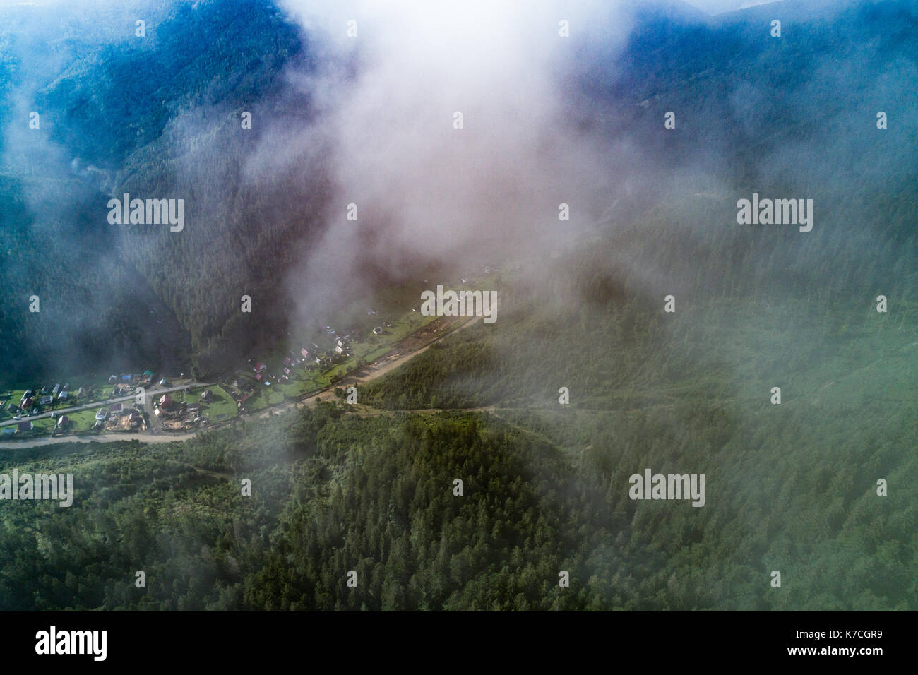 Aerial view of the village in the Carpathian mountains with clouds in ...