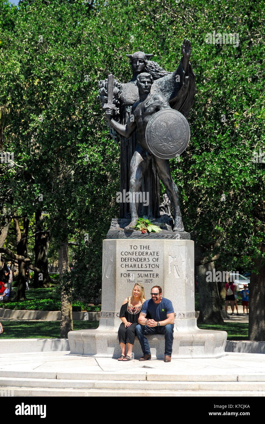 Couple sitting in front of the Confederate Defenders of Charleston