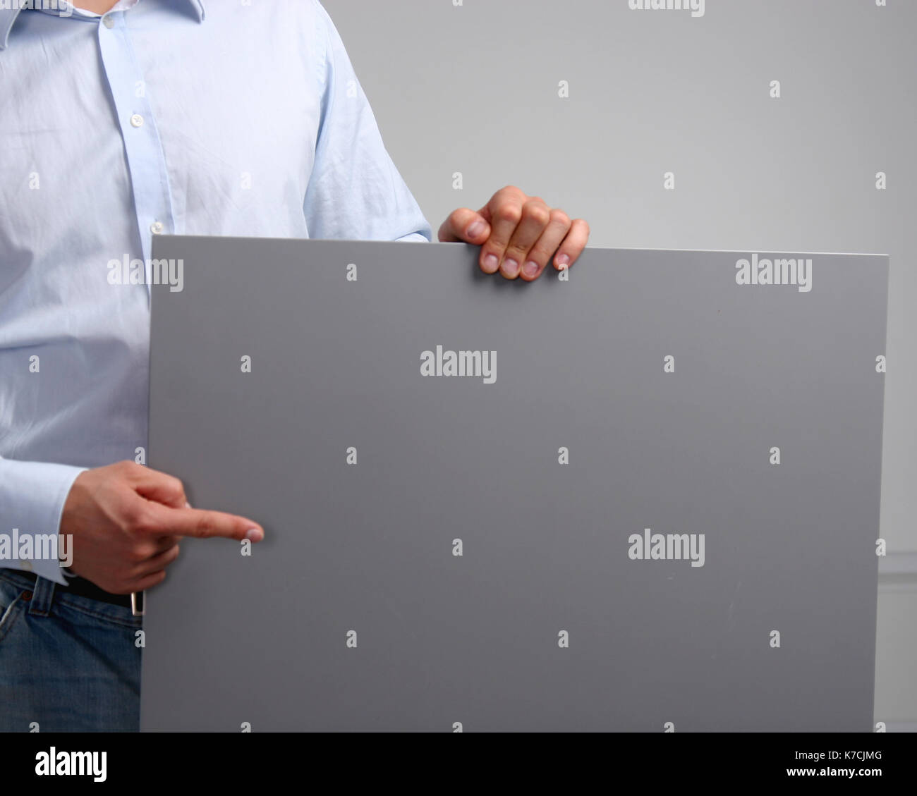 Man showing empty space white placard Stock Photo - Alamy