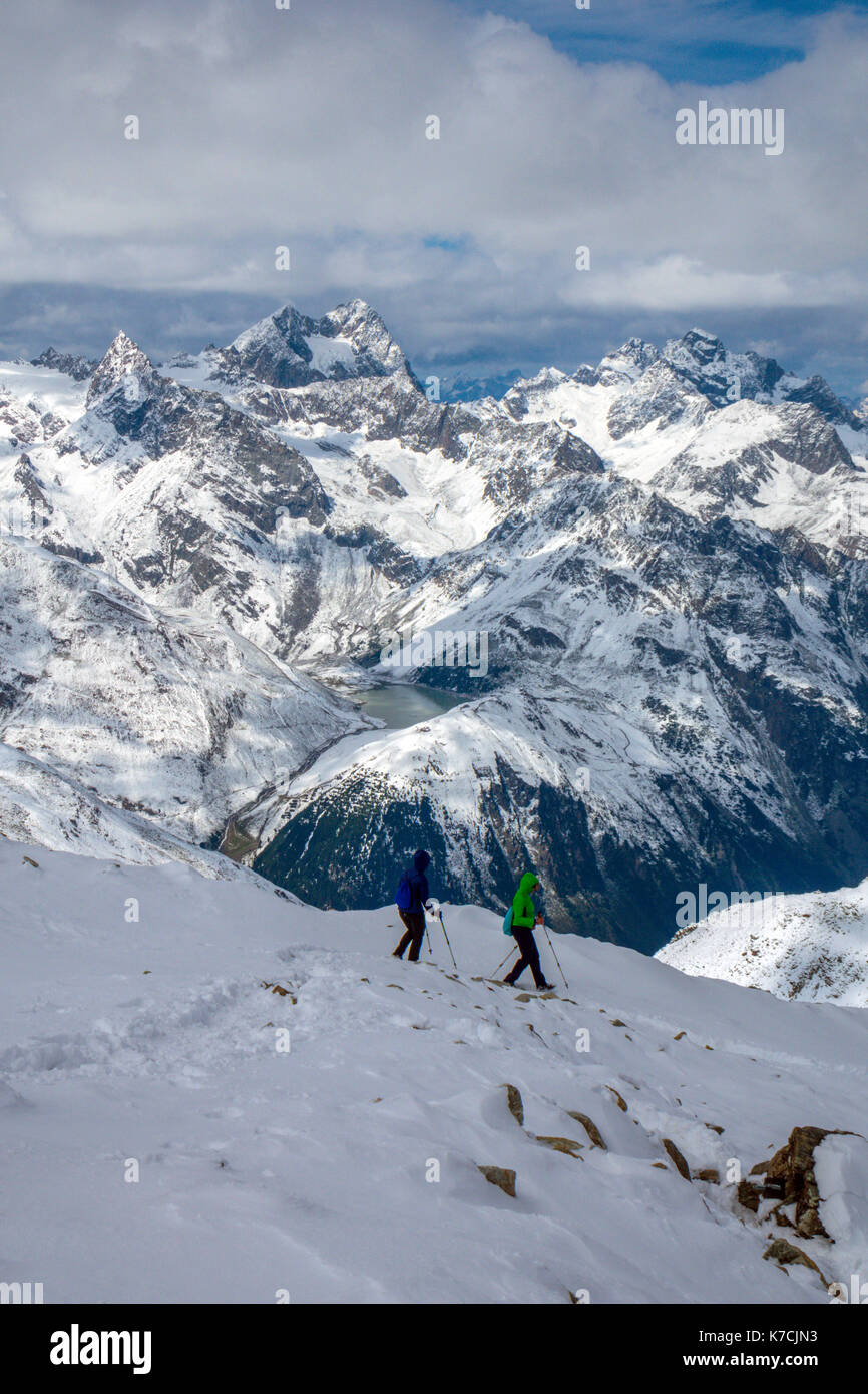 Hikers approaching the snowy summit of Schwarze Schneid, above the cable car, Solden, Austria Stock Photo