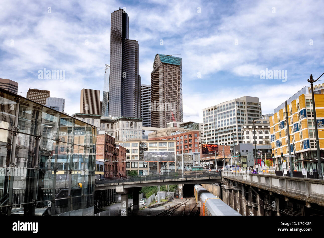 SEATTLE Cityscape showing skyline and a train entering the Great Northern Tunnel, built 1905, a one-mile double tracked railway tunnel Stock Photo