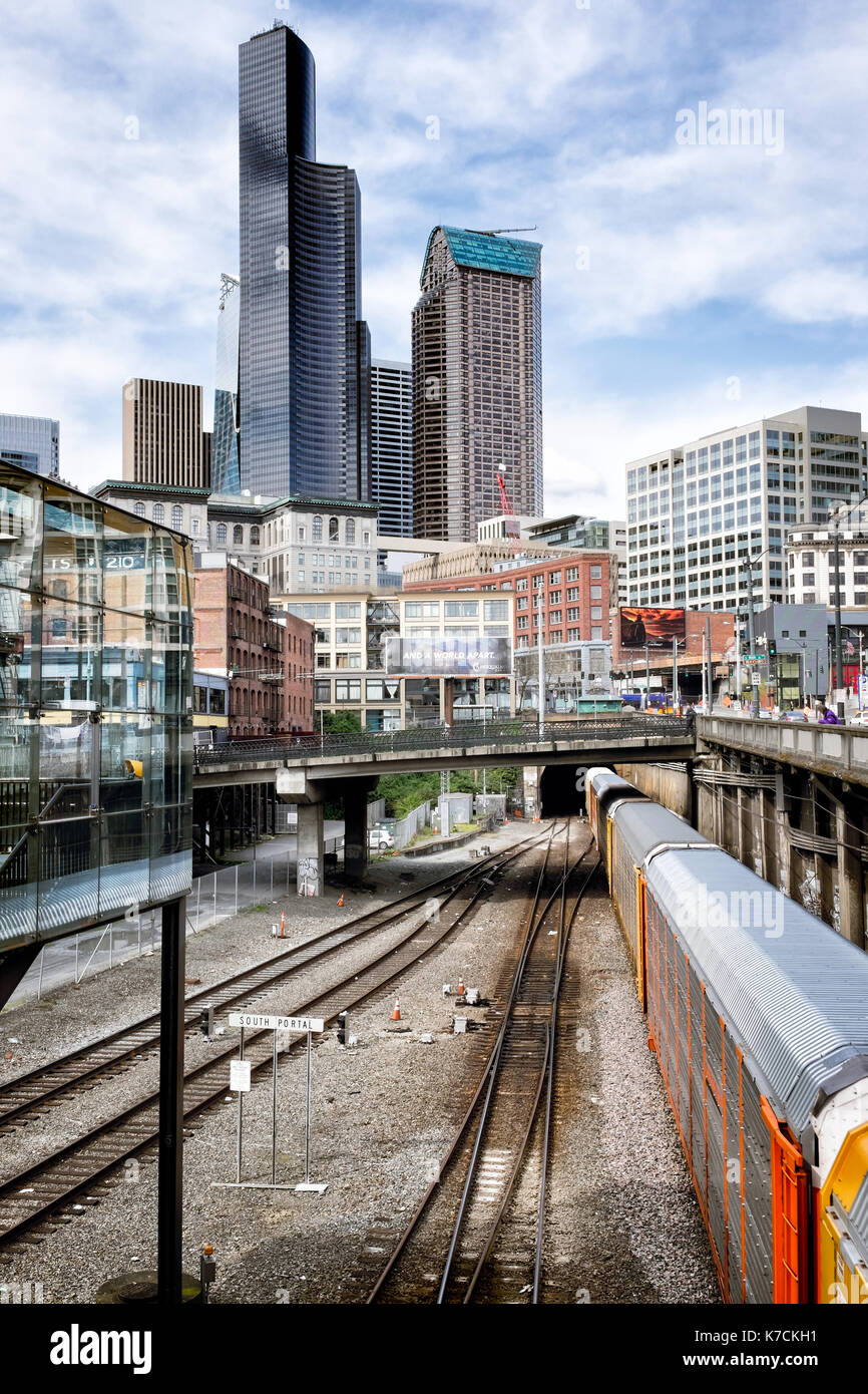 SEATTLE- April 9, 2017: Cityscape showing skyline and a train entering the Great Northern Tunnel, built 1905, a one-mile double tracked railway tunnel Stock Photo