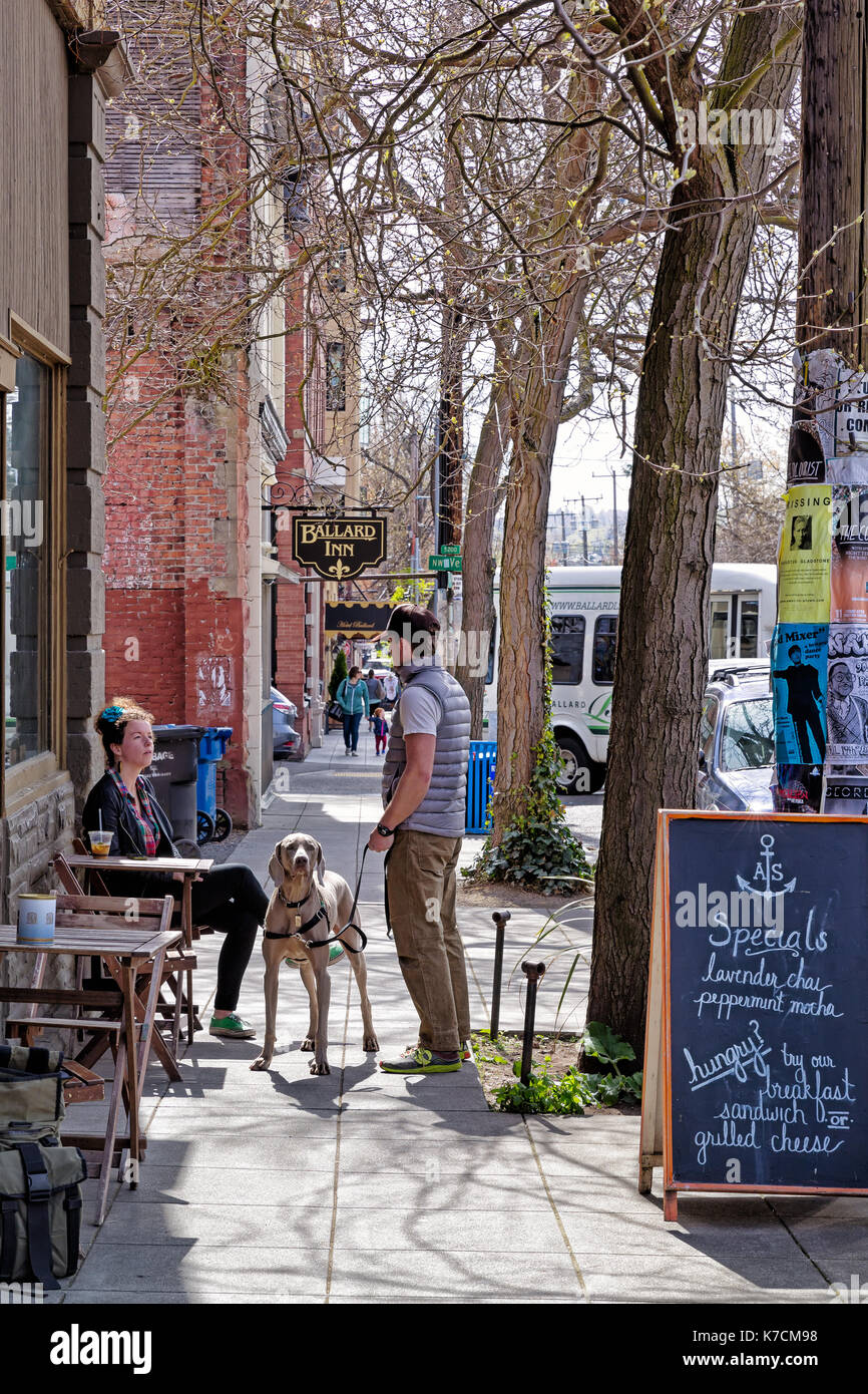 SEATTLE-APR 15, 2014: Coffee drinkers at a sidewalk cafe in Ballard, a popular neighborhood in Seattle known for its historic architecture and a growi Stock Photo