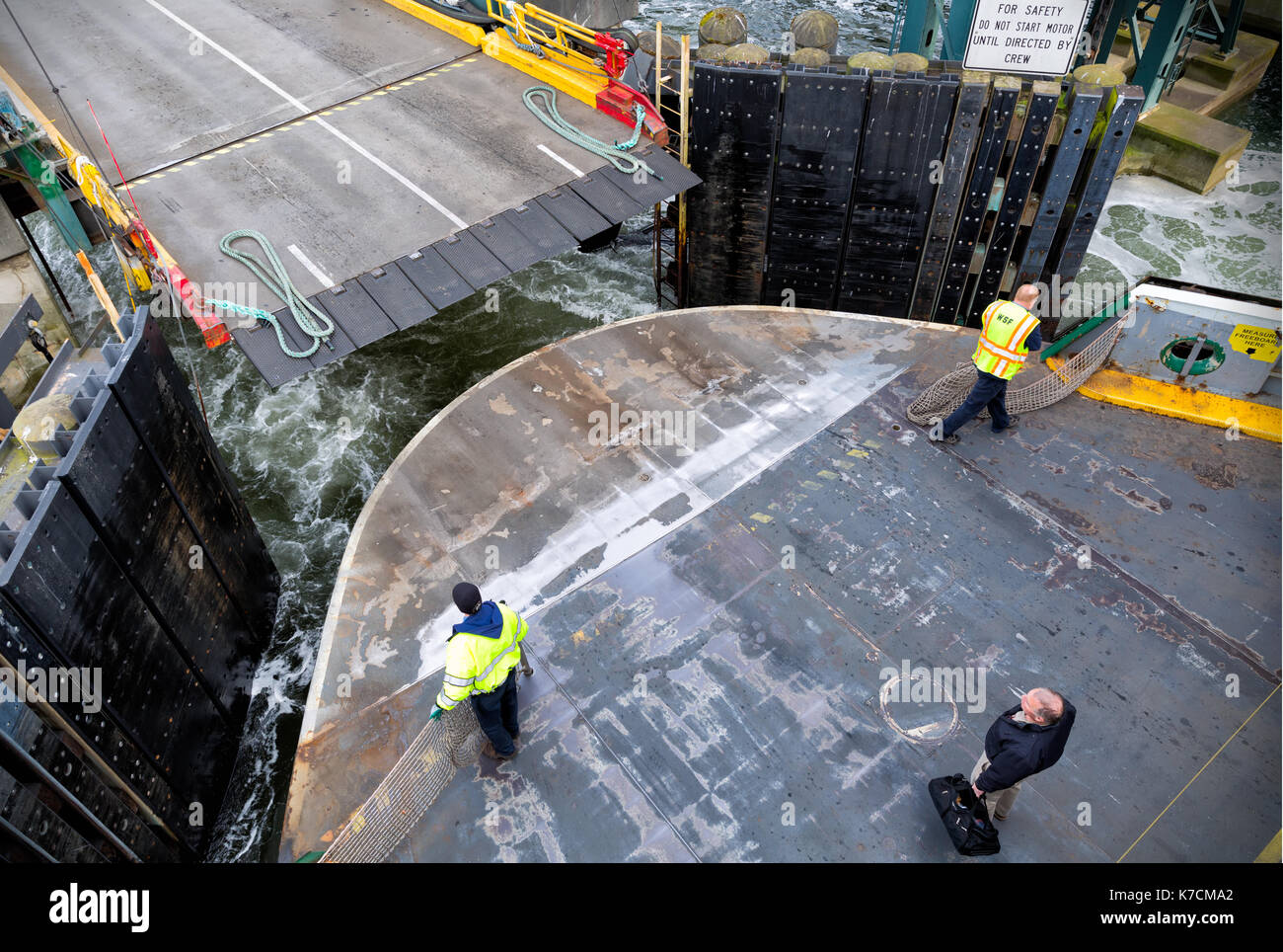 SEATTLE-APR 14, 2014: Washington State Ferry deckhands prepare a car ferry for landing in Seattle. WSF operates 22 ferries carrying more than 22 milli Stock Photo