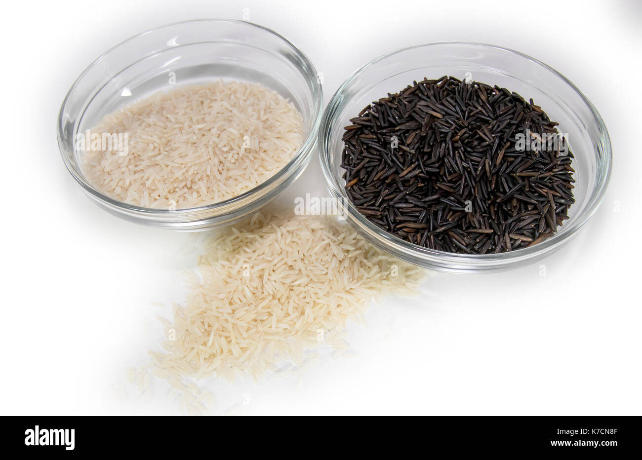 Basmati and wild rice in clear glass bowls Stock Photo