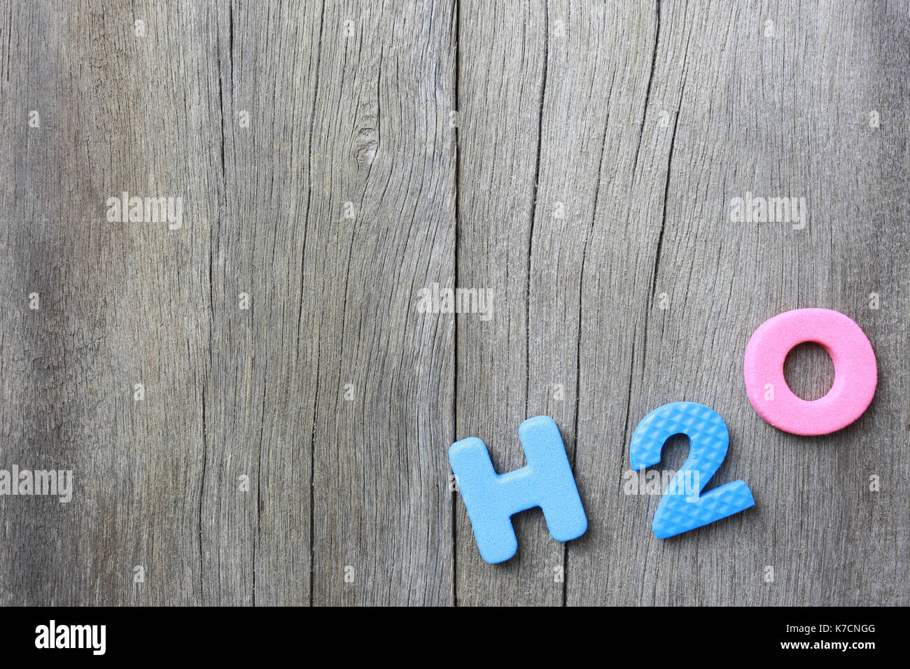 The Alphabet of H2O Lay on old brown wood floor background and have copy space to your work design. Stock Photo