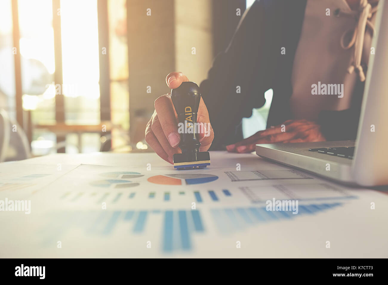 Business concept. Business people Hand Holding Rubber Stamp Over Paid Stamp On Invoice Stock Photo