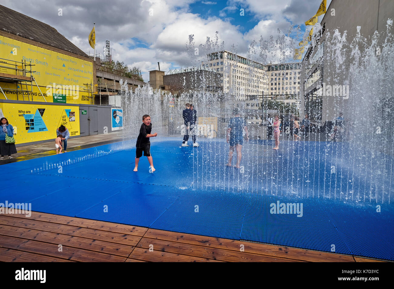 Small boy shouting in fountains at Southbank, London Stock Photo