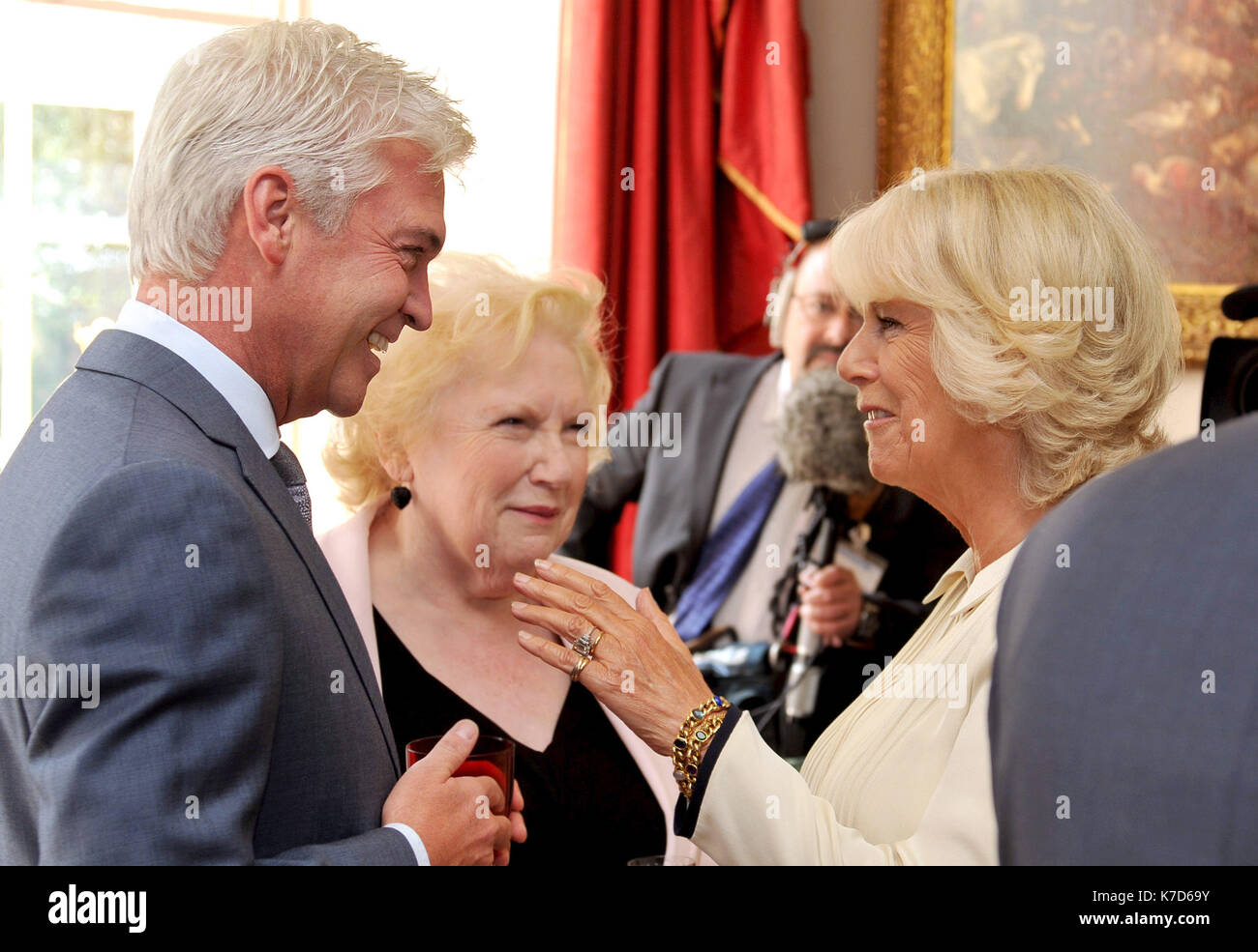 Photo Must Be Credited ©Alpha Press 073074 18/09/12 Camilla The Duchess of Cornwall talks to TV presenter Phillip Schofield and Denise Robertson during a reception for celebrities and volunteers of the Diamond Champions volunteers organised by the Women's Royal Voluntary Service (WRVS), at Clarence House in central London Stock Photo