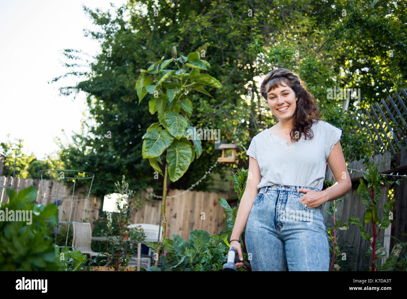 Woman standing in garden plants hi-res stock photography and images - Alamy