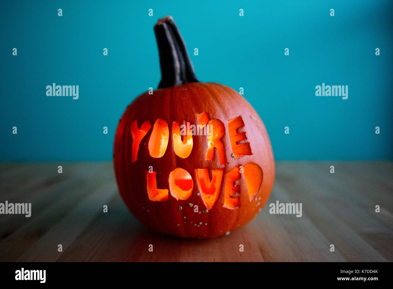 Jack O' lantern on floor against wall Stock Photo