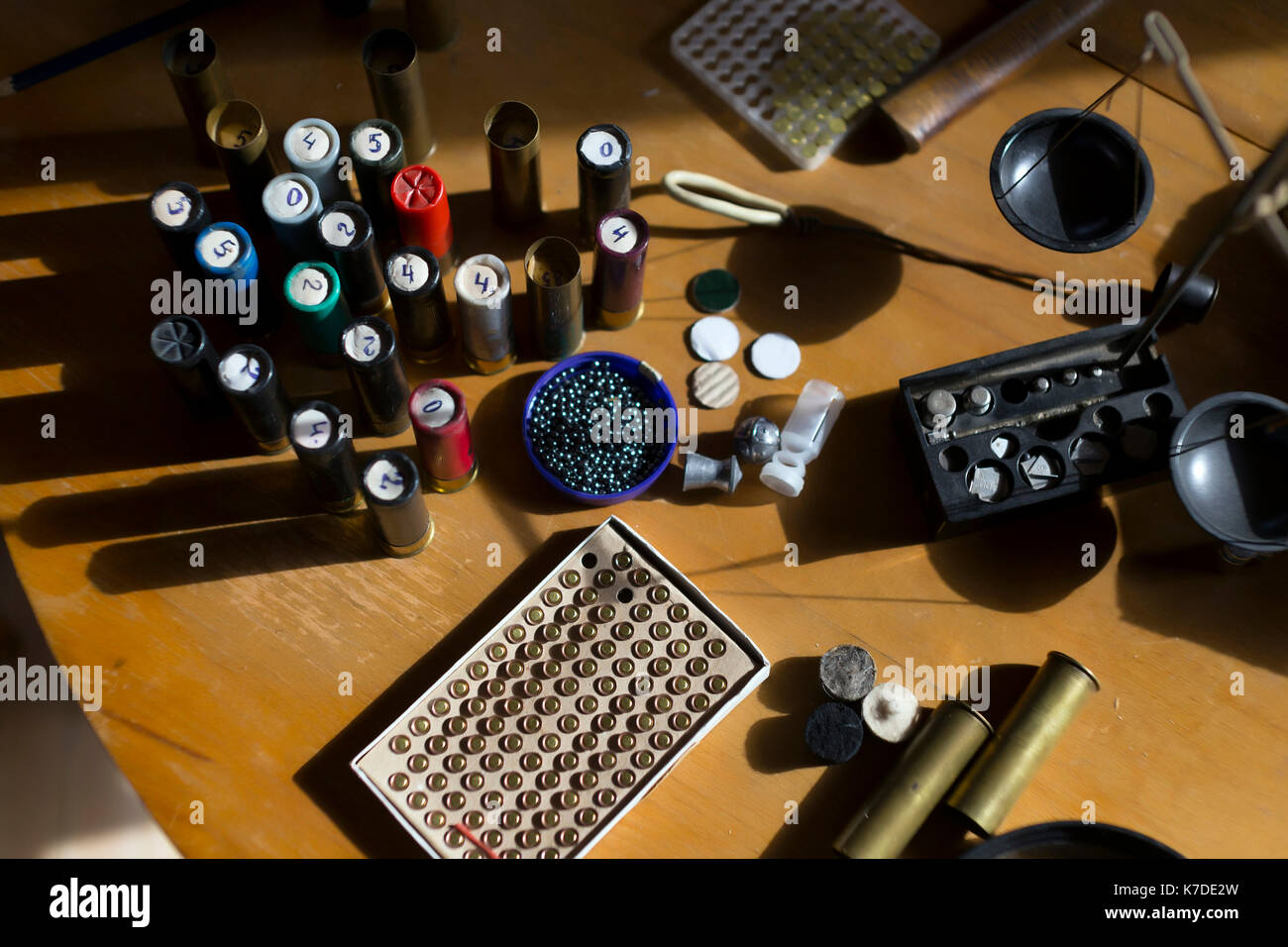 High angle view of cartridges making equipment on wooden table at workshop Stock Photo