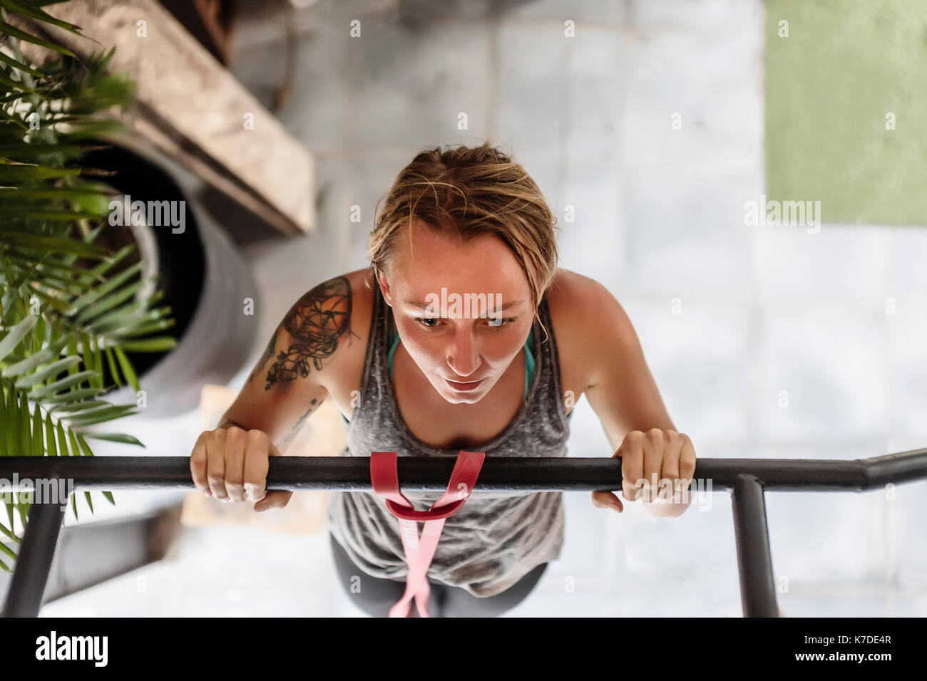 High angle view of woman doing pull-ups at gym Stock Photo