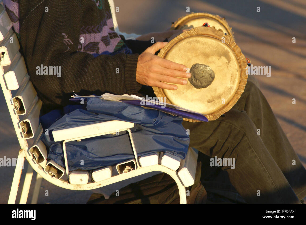 A man in street playing with a tambourine Stock Photo