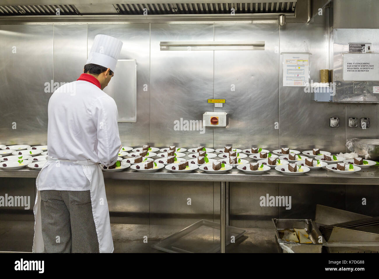 Busy cooks and workers in a commercial kitchen Stock Photo - Alamy