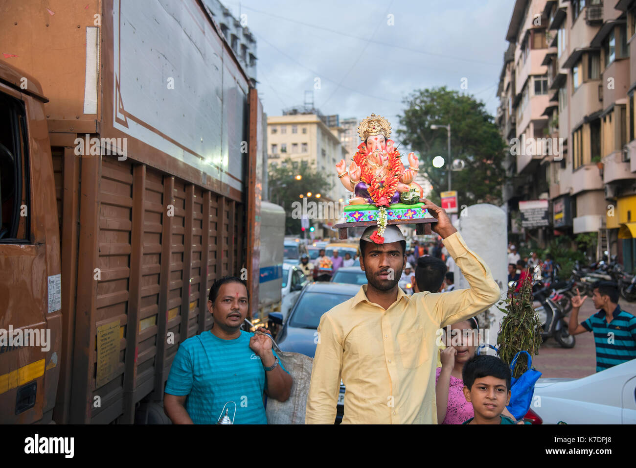 The image of Devotee carrying Ganpati or Elephant headed lords idol  on the way to immersion at Giraguam Chowpatty.Mumbai, India Stock Photo