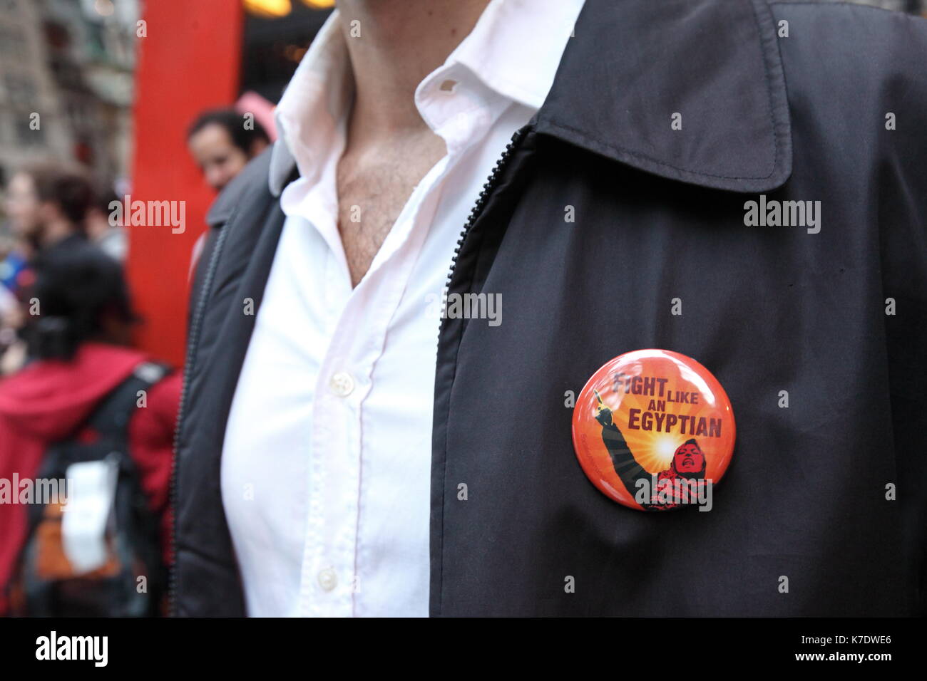 A supporter of the 'Occupy Wall Street' movement wears a pin encouraging protestors to 'FIGHT LIKE AN EQYPTIAN' in Zuccotti Park on the morning of Oct Stock Photo