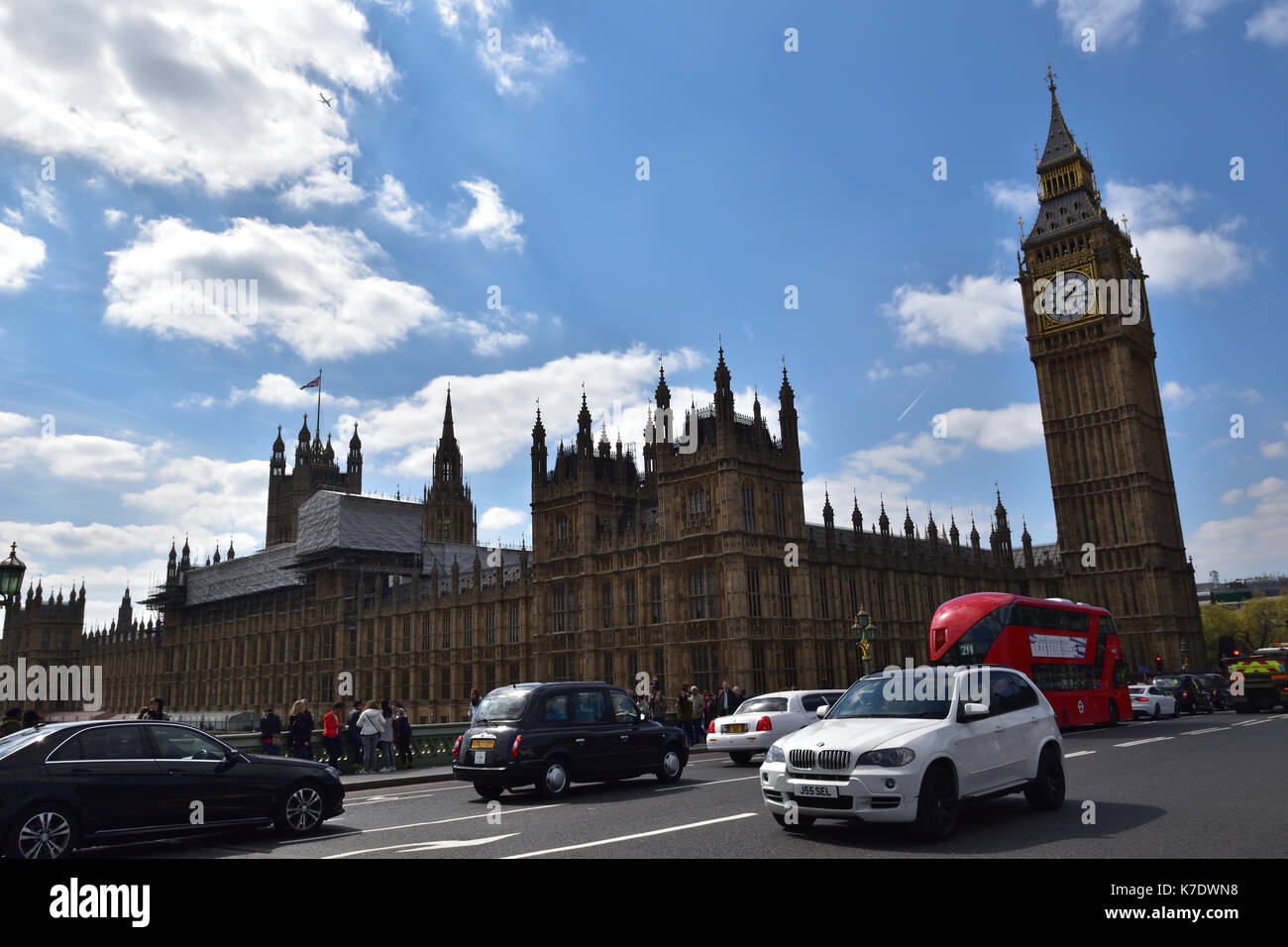 The Palace of Westminster in London is one of the most iconic government buildings worldwide. With Big Ben and bus in front it is a great travel pic Stock Photo