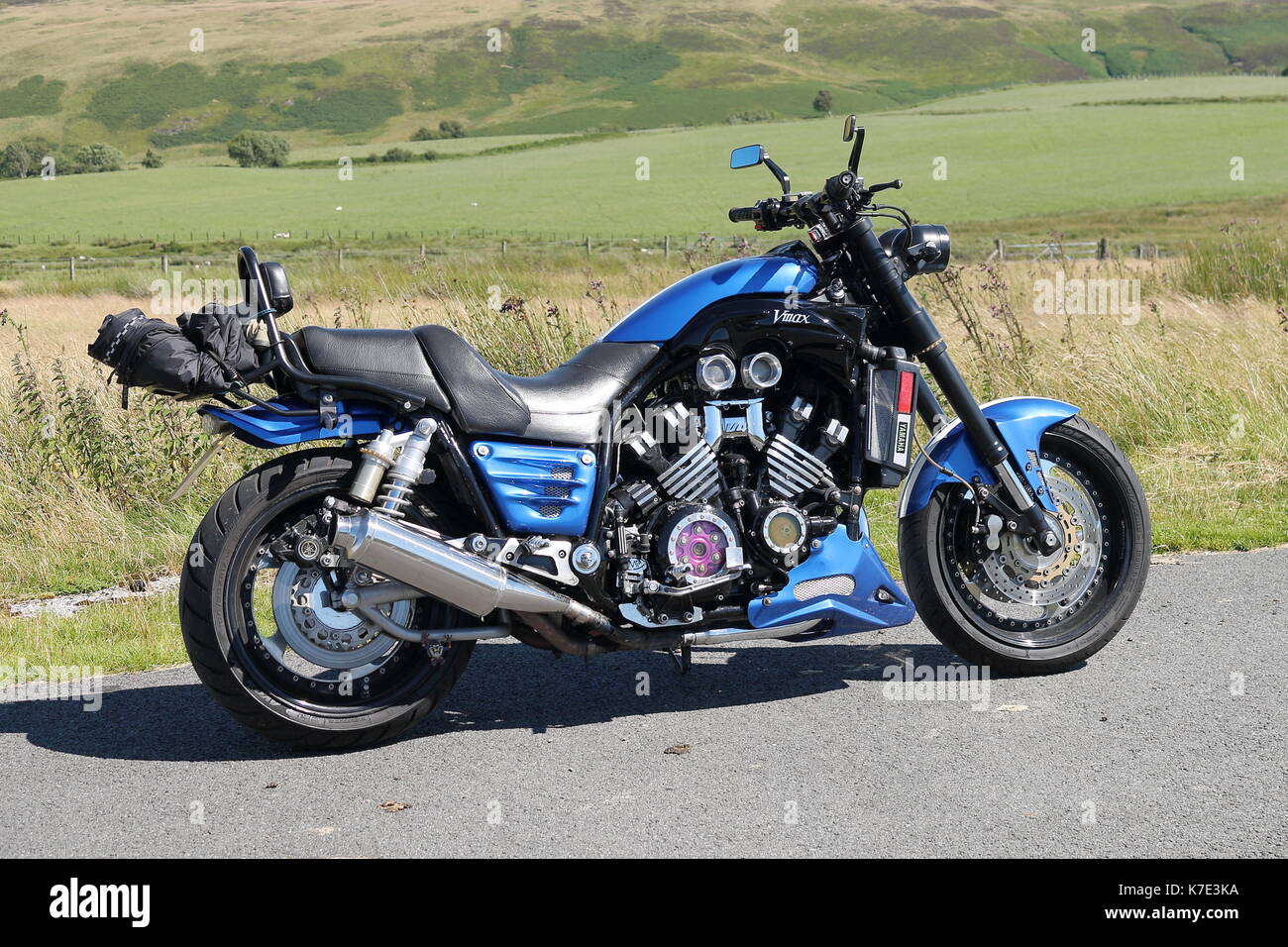 Customised Yamaha vmx 1200cc motorcycle also called  a Vmax parked on a country road in Wales on a sunny day with blue sky and rolling hills Stock Photo