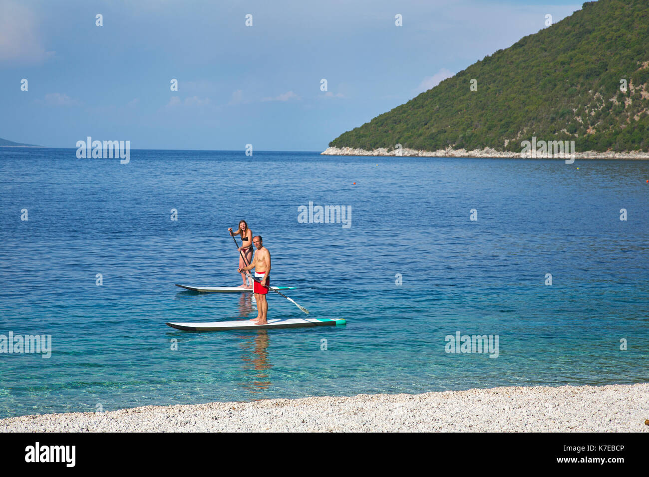 A couple paddle boarding at Andisamos beach Kefalonia Greece,Europe. Stock Photo