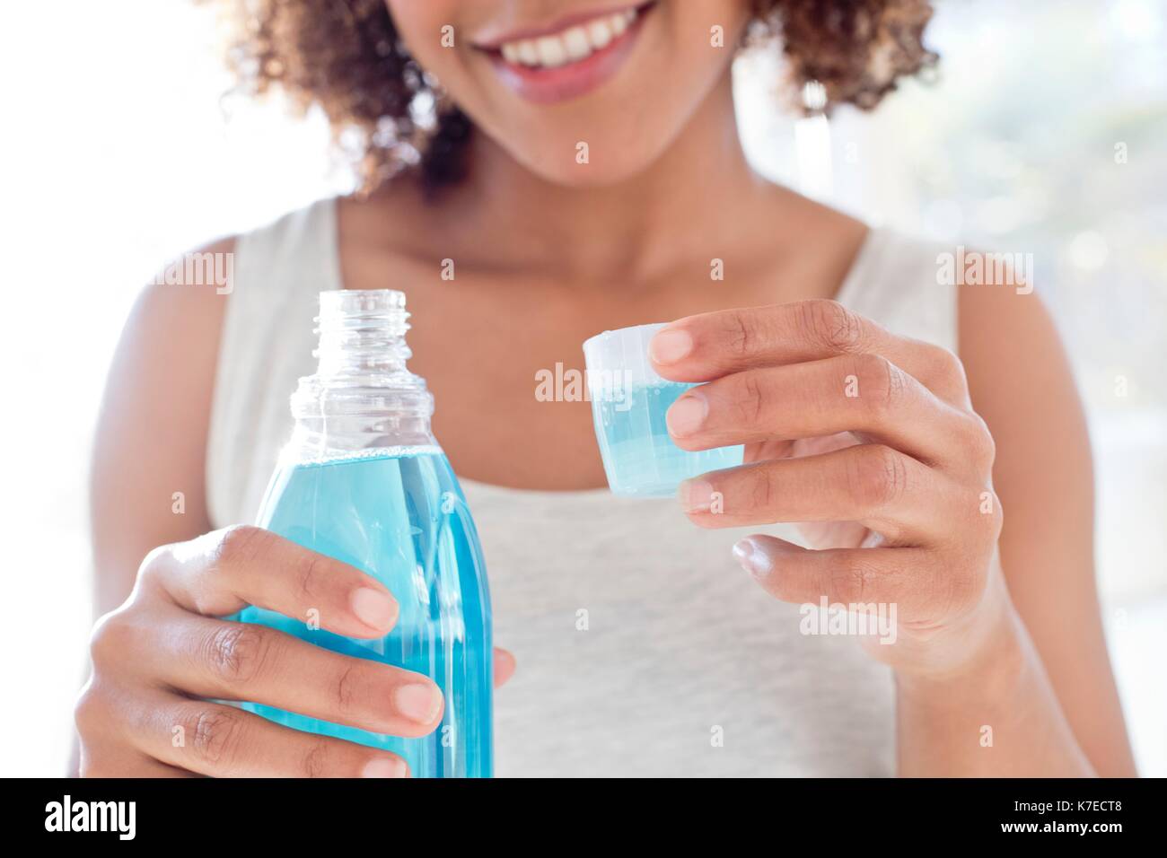 Portrait of mid adult woman using mouthwash Stock Photo Alamy