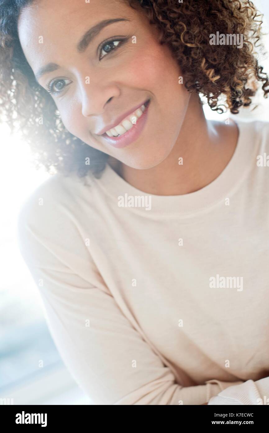 Mid adult woman looking away, smiling. Stock Photo