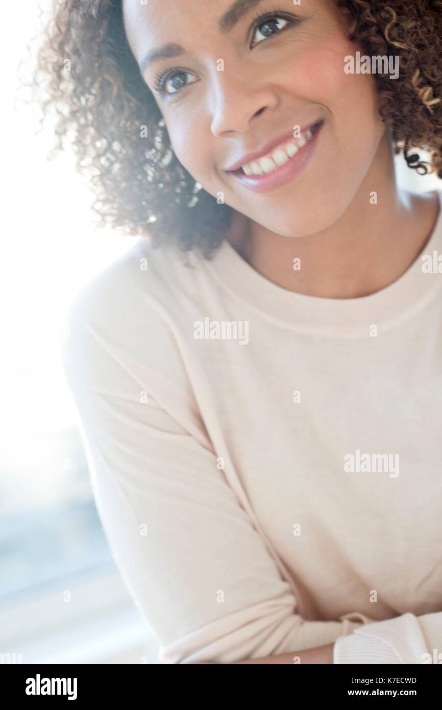 Mid adult woman looking away, smiling. Stock Photo