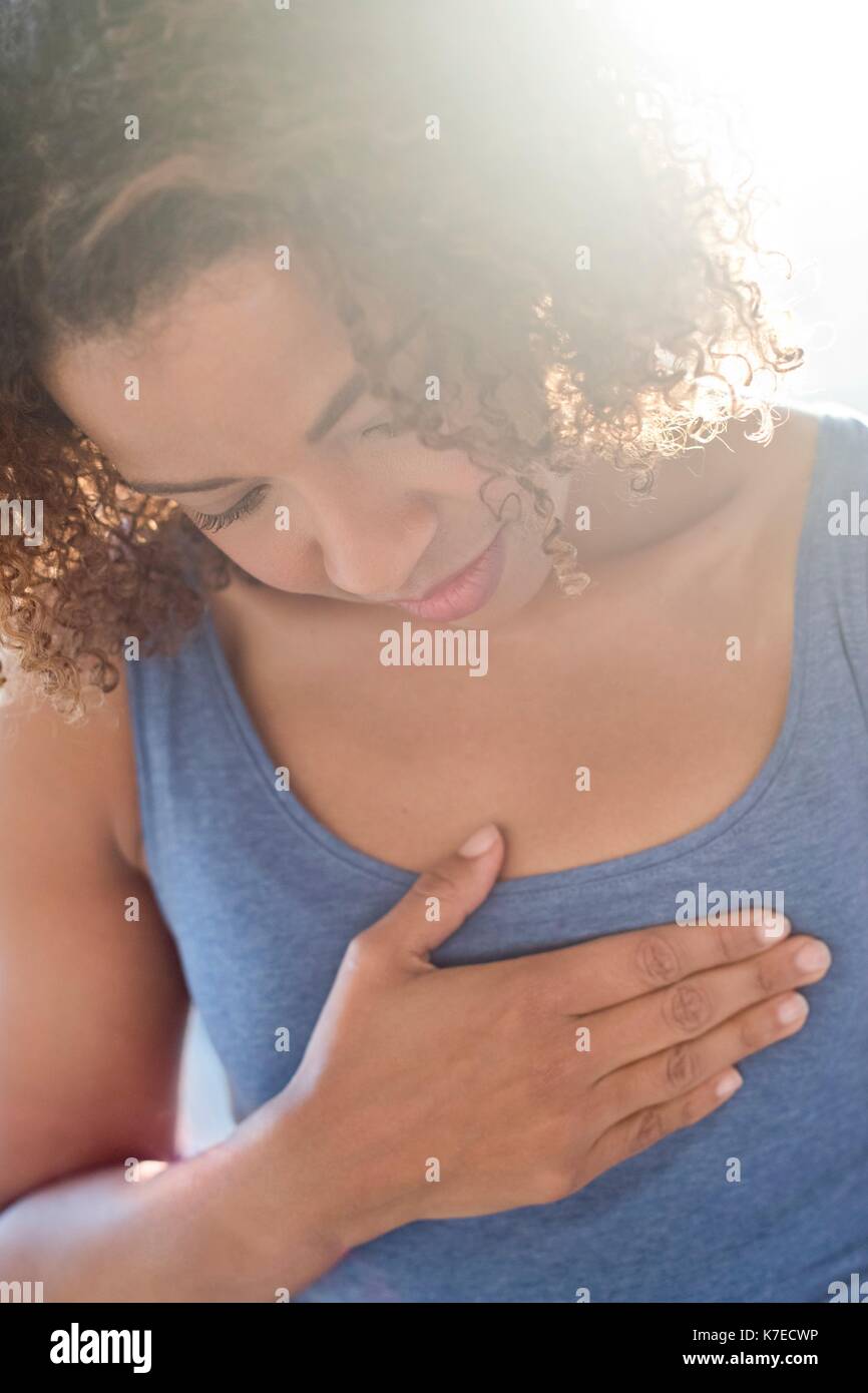 Woman touching chest. Stock Photo