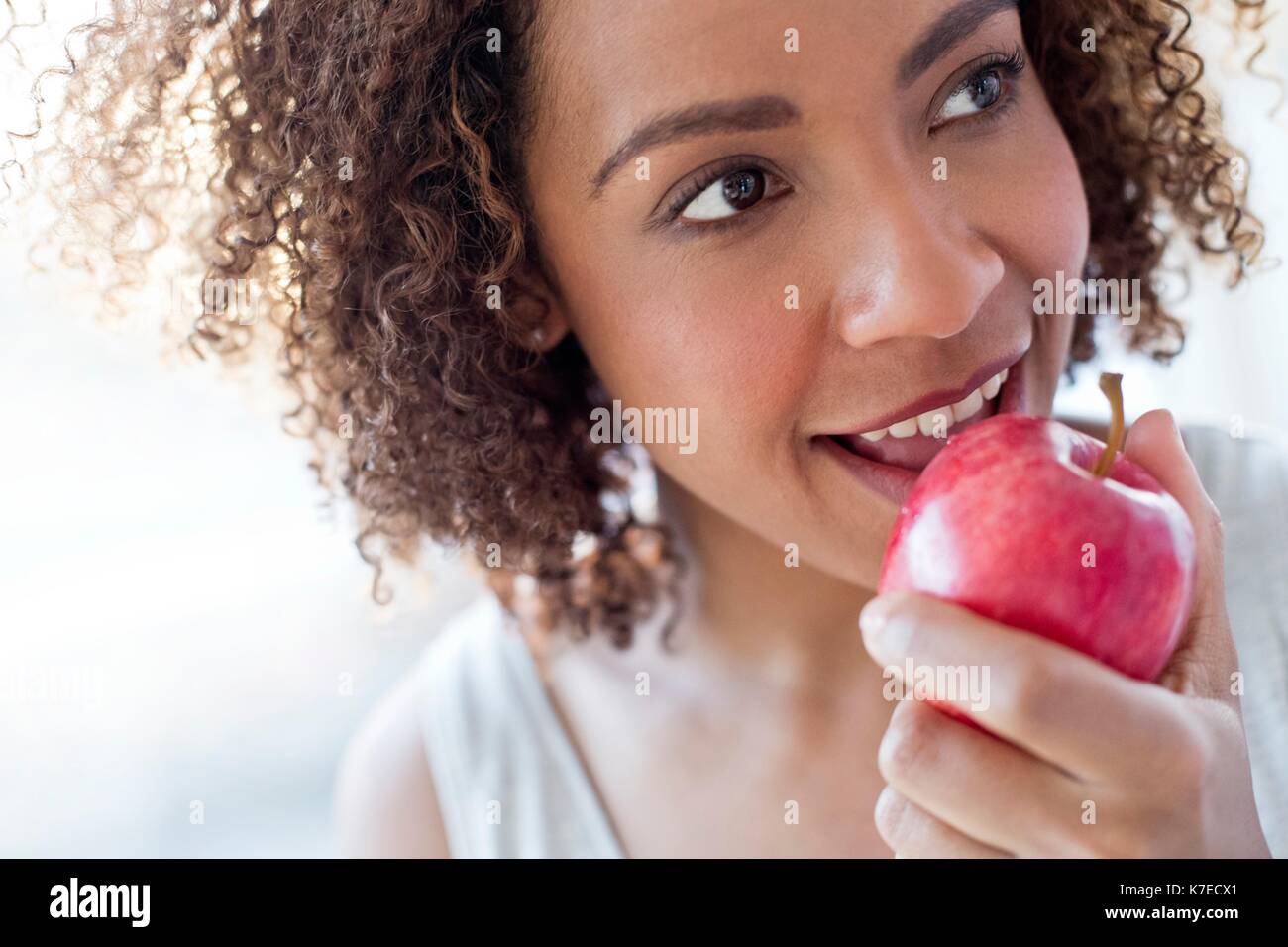 Mid adult woman eating apple. Stock Photo