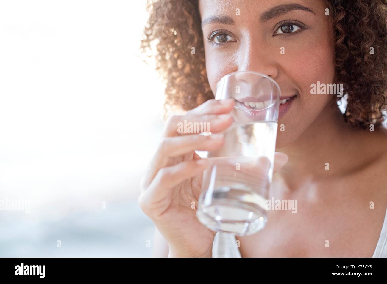 Mid adult woman drinking water. Stock Photo