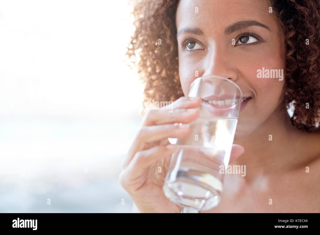 Mid adult woman drinking water. Stock Photo