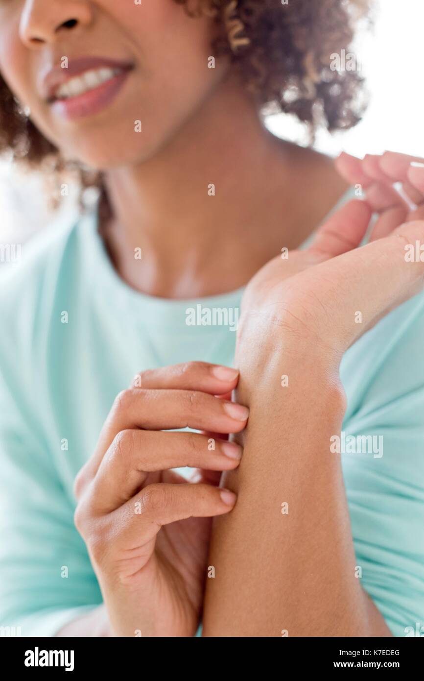 Woman scratching wrist. Stock Photo