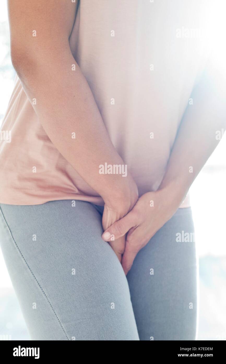 Woman clutching stomach in pain. Stock Photo