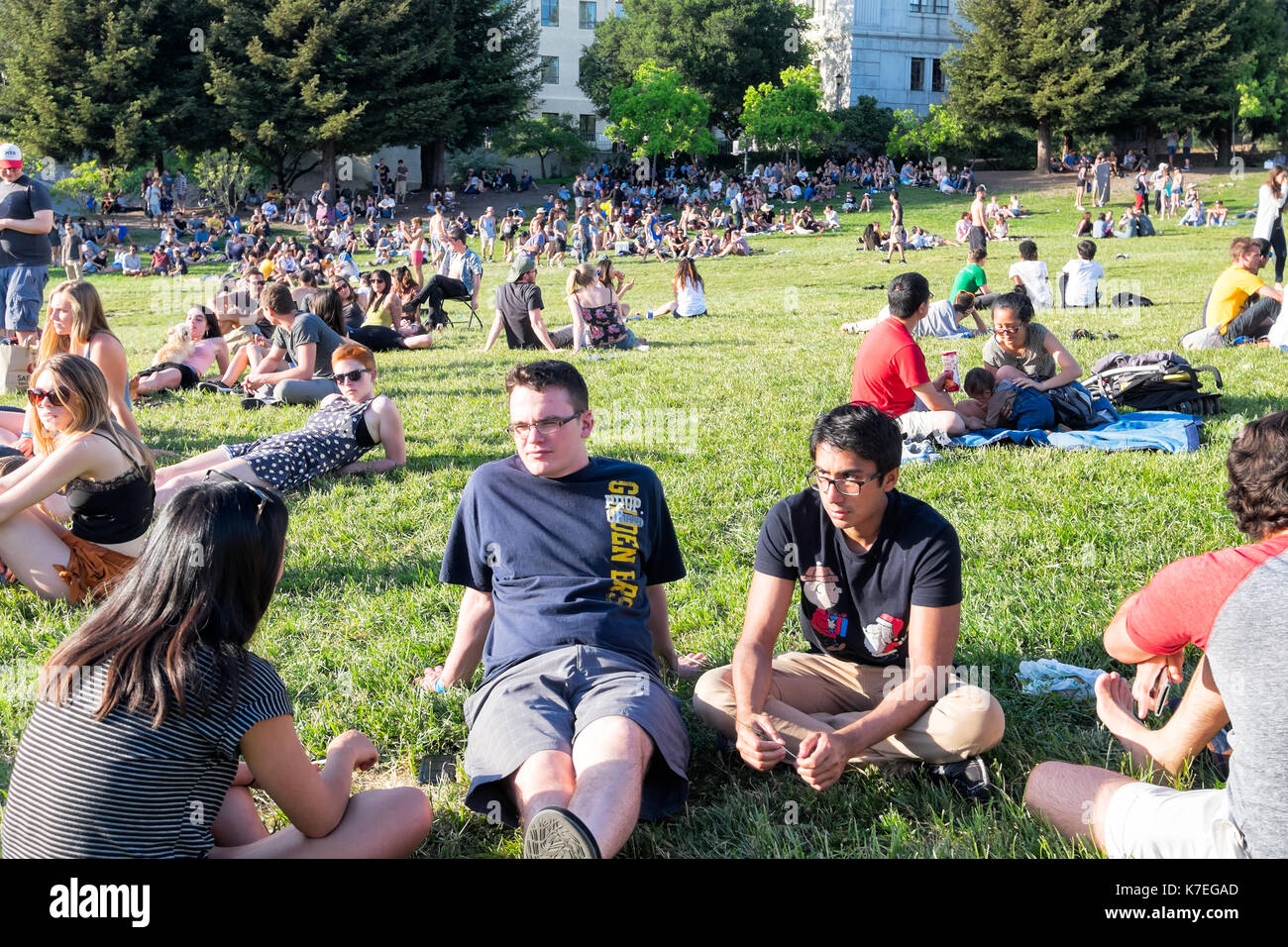 BERKELEY, CA- Apr 17, 2016: Crowds of students at the University of California Berkeley relaxing outdoors in the sun on a grassy open space. Stock Photo