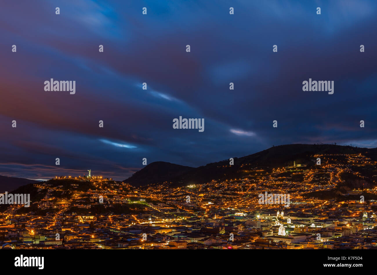 Cityscape of Quito with its illuminated historic city center during the blue hour, Ecuador. Stock Photo