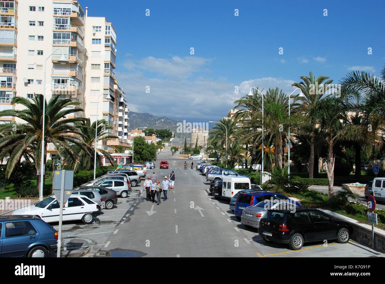 Car parking between apartment blocks with Torre Derecha watchtower to the rear, Lagos, Malaga Province, Andalusia, Spain, Western Europe. Stock Photo