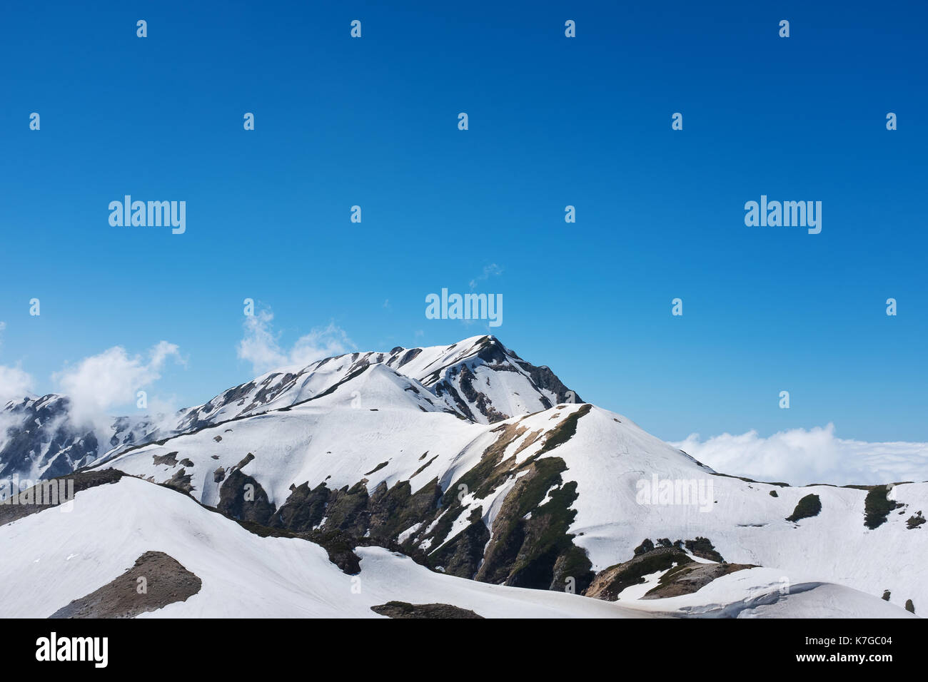 snow capped mountain landscape with blue sky Stock Photo - Alamy
