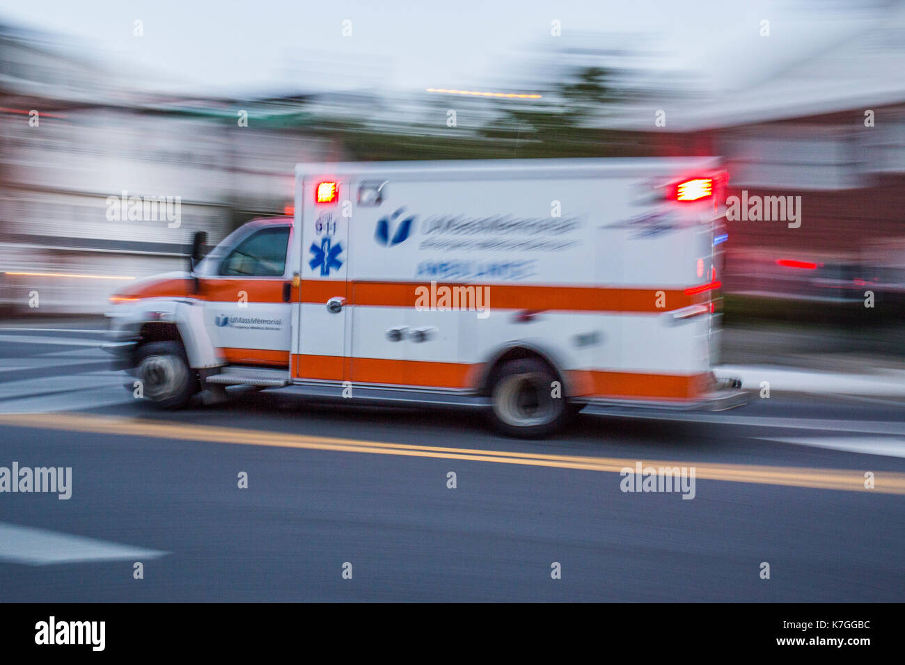 An ambulance rushes  along Highland Street in Worcester, Massachusetts Stock Photo