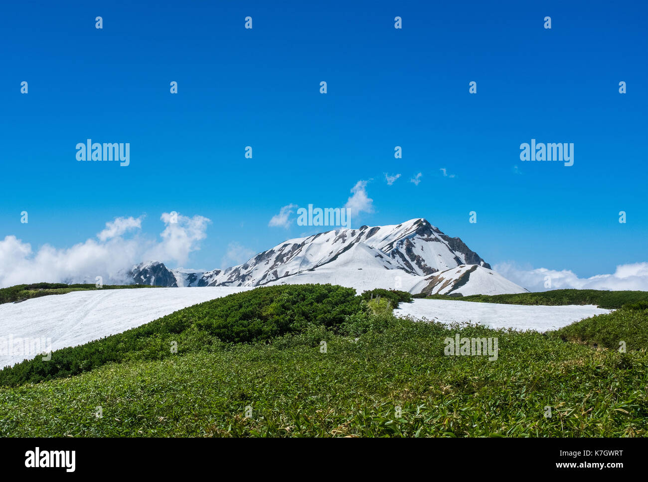 TATEYAMA, JAPAN - June 11, 2017: Japan Alps with melting snow. The Tateyama Kurobe Alpine route operate in late April until November, is one of the to Stock Photo