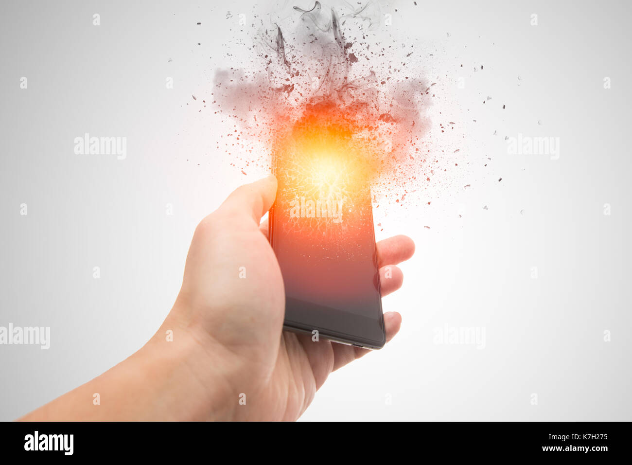 smartphone explosion, blow up cellphone battery or explosive mobile phone or explode burst fire burn out smart device with dispersion effect. Stock Photo