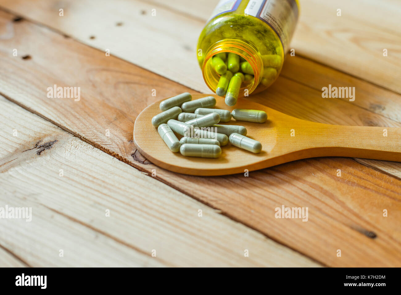 herbal in capsule on wood table background Stock Photo