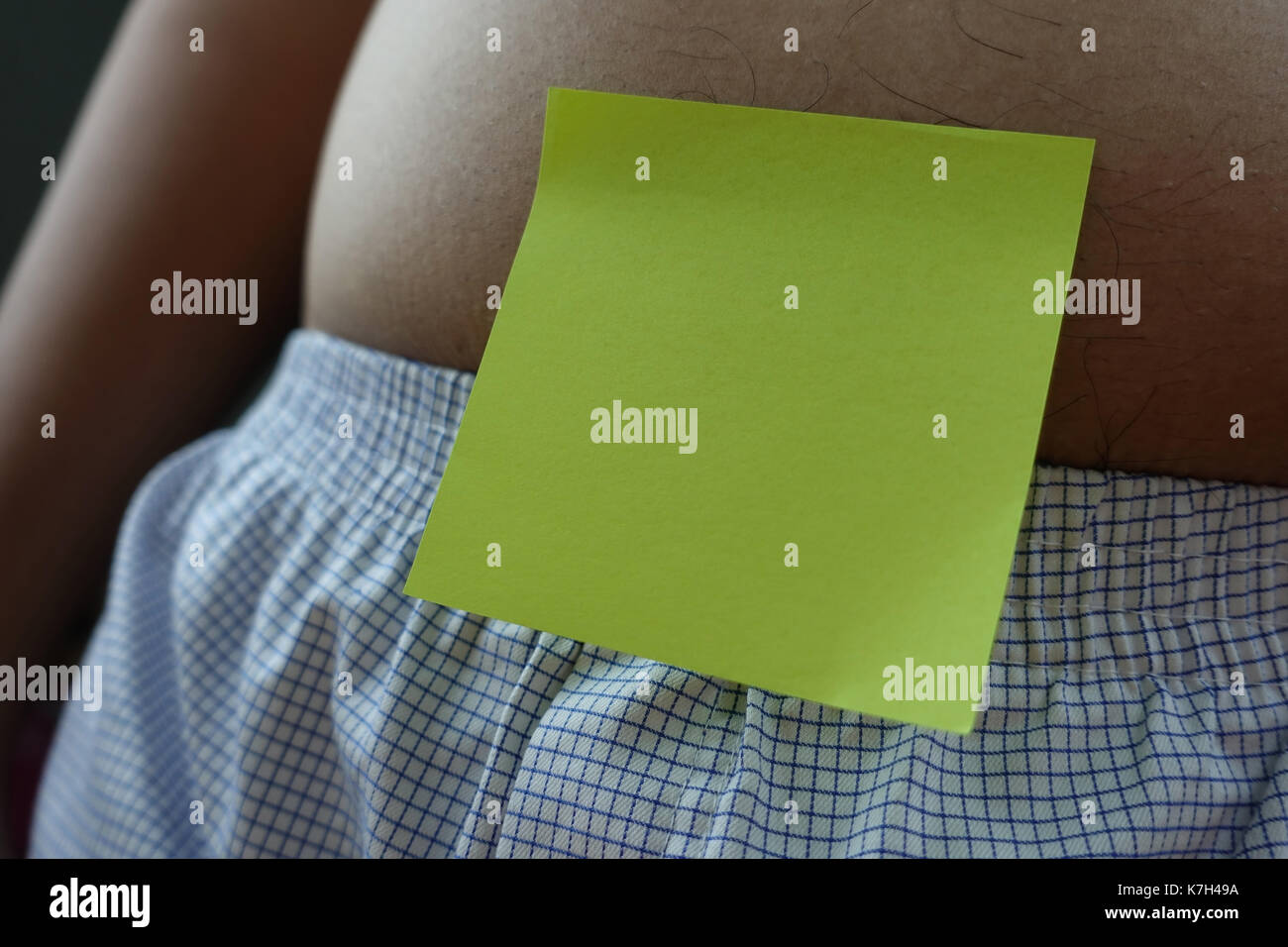 belly of a fat man with green post note paper sticker - closeup Stock Photo
