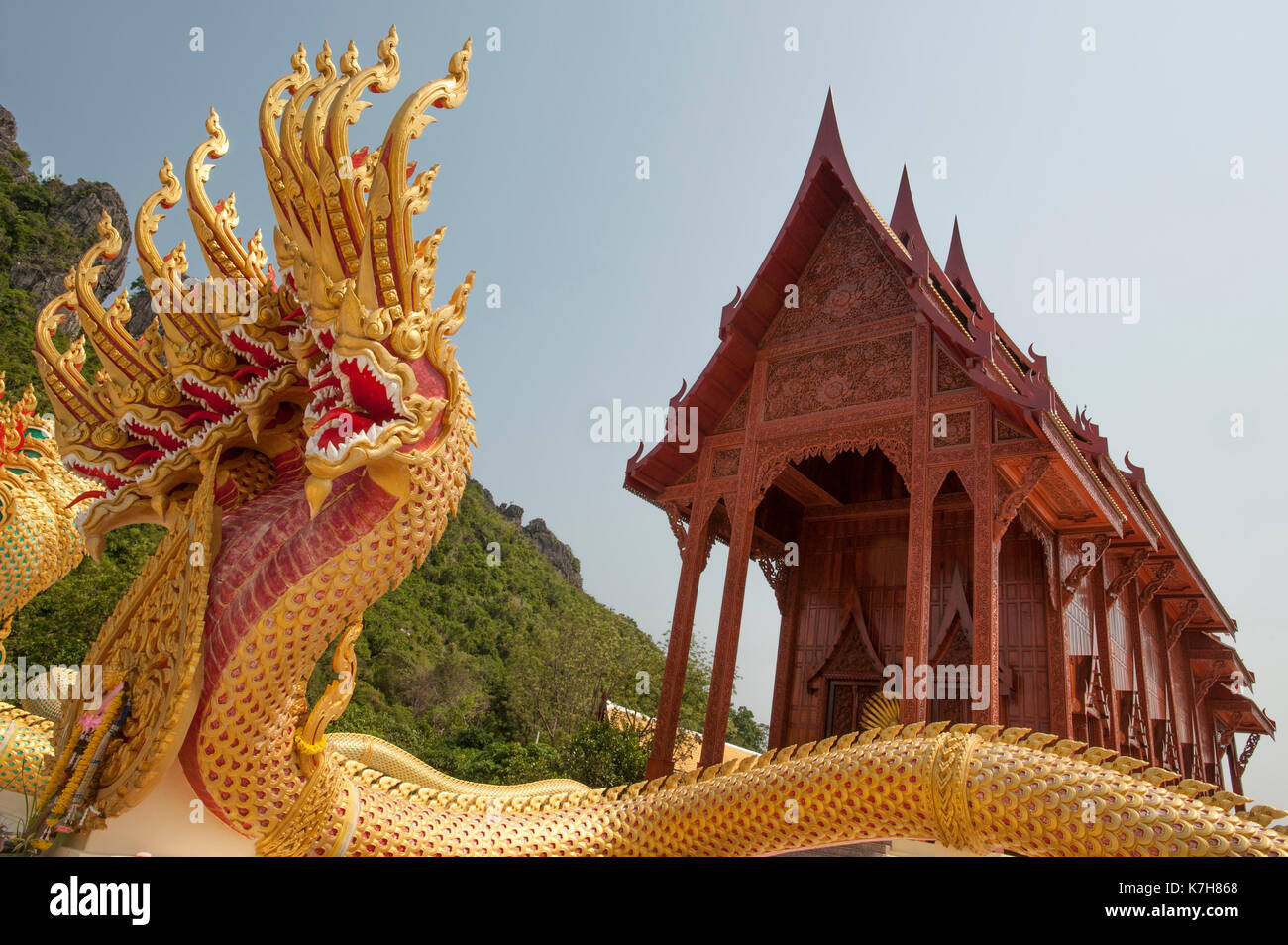 Red and Gold nine-headed naga protecting the entrance of the Teak wood temple Wat Ao Noi, Prachuap Khiri Khan, Thailand, Southeast Asia Stock Photo