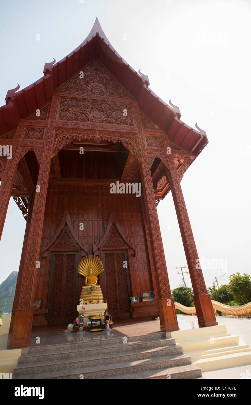 Buddha and Naga statue outside the entrance of the Teak wood temple Wat Ao Noi, Prachuap Khiri Khan, Thailand, Southeast Asia Stock Photo